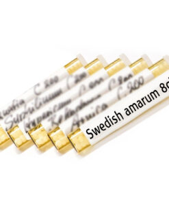 Globules in brown glass tube